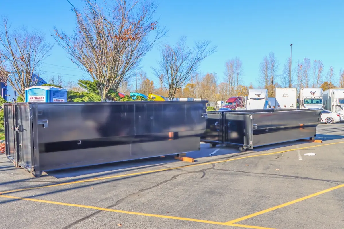 Professional dumpster rental service with roll-off container on residential driveway in Alice